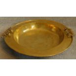 A large Oriental vintage beaten brass bowl with pair of swing handles. 65x65cm