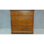 An Edwardian mahogany chest of two short over three long drawers raised on pebble feet. H.123 W.