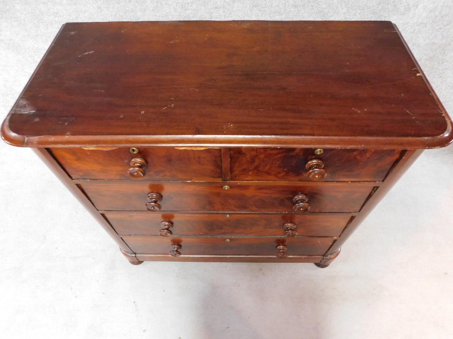 A Victorian mahogany chest of two short over three long drawers, raised on squat turned supports. - Image 4 of 8