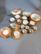 A 20th century gilded floral design porcelain part tea set. Marked to the base of each piece with