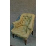 A Victorian armchair with cream and floral upholstery, raised on turned tapering supports. H.87cm