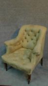 A Victorian armchair with cream and floral upholstery, raised on turned tapering supports. H.87cm