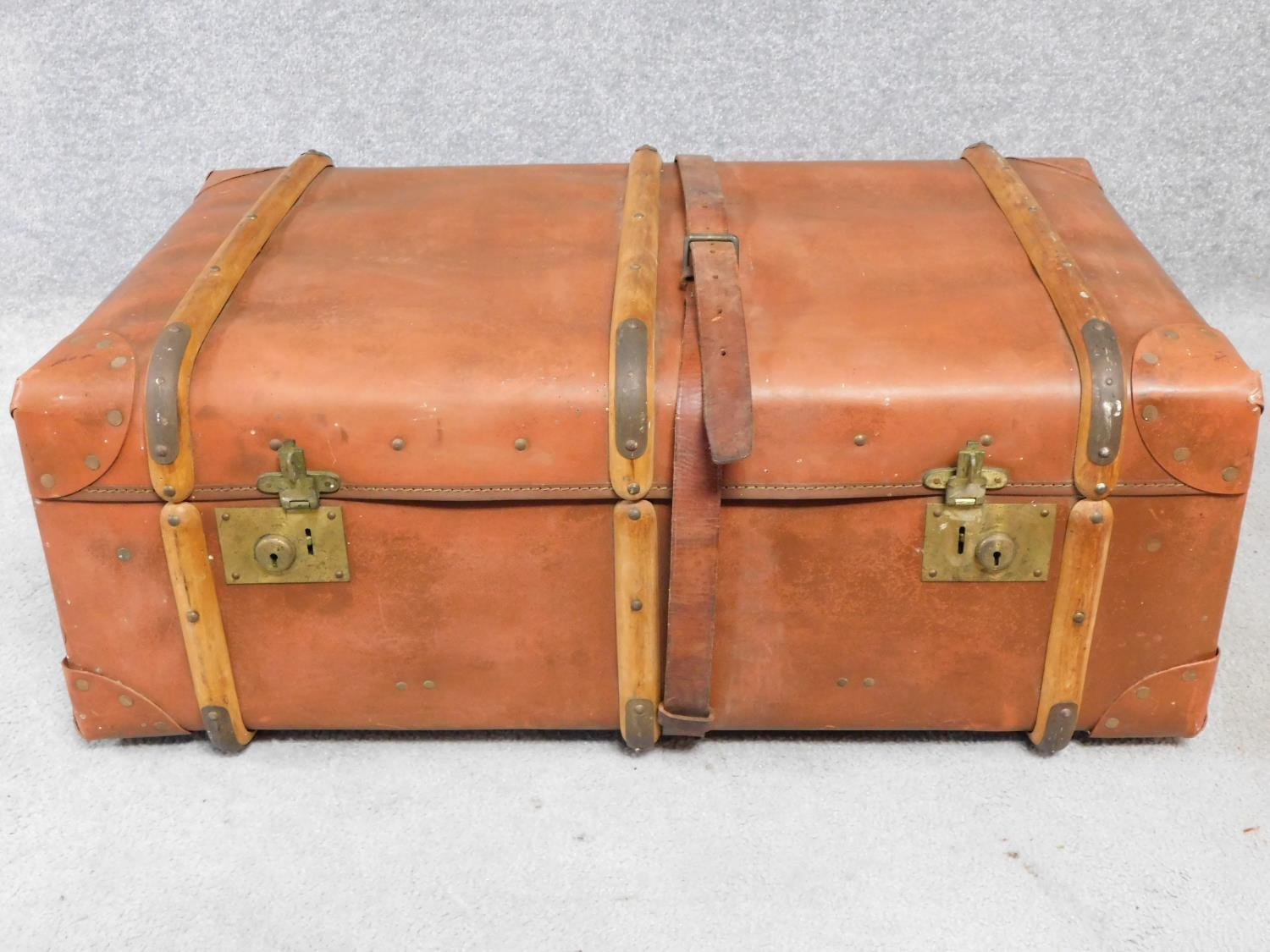 A vintage leather and wood steamer trunk. H.34 W.84 D.54cm