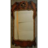 A Georgian mahogany and carved gilt fret carved wall mirror with original plate. 94x52cm