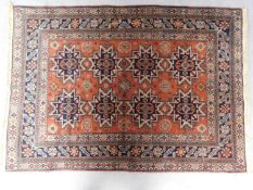 A Caucasian style rug, with repeating star medallions on a rouge field 166x114cm