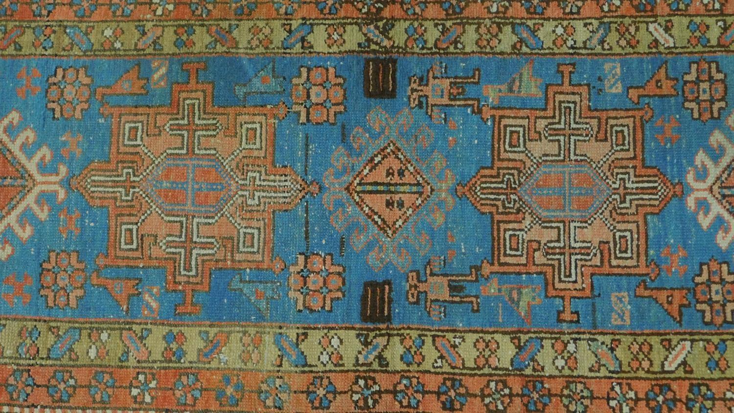 A Persian Heriz style runner, repeating stylised medallion throughout the field guarded by multi - Image 2 of 4