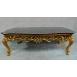 A gilt Rococo style coffee table with shaped marble top. H.47 W.139 D.79cm