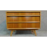 A vintage oak chest of three drawers by Hunt for James Philips & Sons raised on splay legs, makers