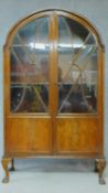 A mid 20th century Art Deco style mahogany bookcase, astragal glazed section above panel doors