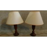 A pair of painted and ebonised turned table lamps and shades. H.58cm
