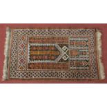 A prayer rug with repeating floral columns with geometric borders. 149x82cm