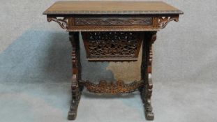 An Anglo Indian teak work table with all-over floral carving fitted with frieze drawer and slide out