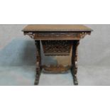 An Anglo Indian teak work table with all-over floral carving fitted with frieze drawer and slide out