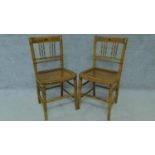 A pair of 19th century faux bamboo cane seated chairs with hand painted floral design and raised