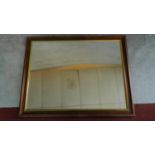 A large rectangular gilt and mahogany framed wall mirror. 92x115cm