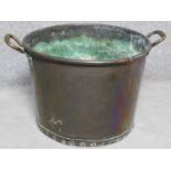 A Victorian copper two handled pot with rivet details. H.42cm