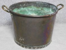 A Victorian copper two handled pot with rivet details. H.42cm