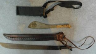 Two vintage machetes. The larger blade has a leather sheath and is stamped Imacasa on the handle.