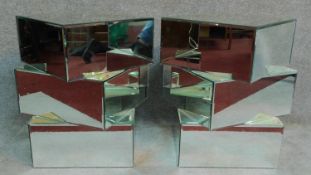 A pair of contemporary mirrored pedestals of abstract geometric form. H.59cm