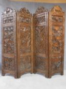 An Anglo Indian hardwood three fold four panel screen with allover well carved foliate decoration. H