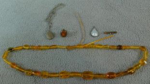 A collection of jewellery including a White metal and Amber ring, a White metal mounted blister