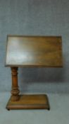 A 19th century mahogany adjustable and tilting reading stand on fluted support on platform catered