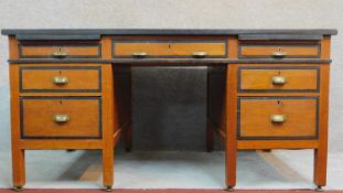 An early 20th Century oak and ebonised pedestal desk on square supports. H.76 W.153 D.89cm