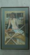 A framed and glazed pastel of a nude lady on a bed. 60x41cm