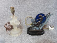 A pair of Art Deco lamps. One of a cast bronze dancer in front of a stain glass abstract glass panel