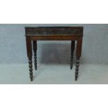 A late 19th Century oak writing desk with floral carving and bobbin turned supports. H.70 W.66 D.