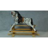A vintage carved piebald rocking horse with lift off top section. H.115 W.156cm