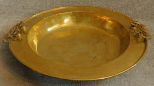 A large Oriental vintage beaten brass bowl with pair of swing handles. 65x65cm