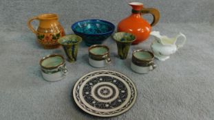 A collection of vintage studio pottery. Including a West German orange glazed jug with wooden