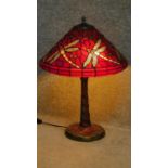 A Tiffany style table lamp with dragonfly decoration to shade and base. H.60cm