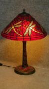 A Tiffany style table lamp with dragonfly decoration to shade and base. H.60cm