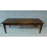 A early 20th Century teak refectory dining table raised on square tapering supports. H.78 W.250 D.