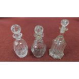 Three antique cut glass decanters. One Victorian 'Newcastle bell' blown glass decanter with