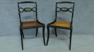 A pair of Regency ebonised caned seated chairs with rope twist top rails and brass eagle motifs,