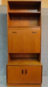 A mid 20th Century two section teak bureau bookcase with mirrored and lit interior, by G-plan. H.198