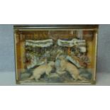 An antique cased taxidermy study of two otters beneath a frozen rock face, with substrate. Brass