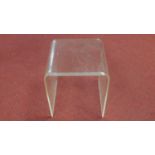 A moulded perspex occasional table. H.43 W.41 D.43cm