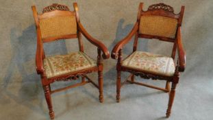 A pair of 19th century Italian fruitwood carved armchairs in floral upholstery raised on turned