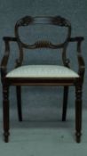 A George IV mahogany carved armchair with sage floral drop in seat raised on turned reeded