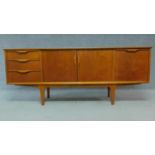 A mid 20th Century teak sideboard fitted cupboards and drawers raised on tapering supports. H.73 W.