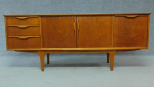 A mid 20th Century teak sideboard fitted cupboards and drawers raised on tapering supports. H.73 W.