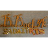 A collection of vintage wooden and gilded shop name letters. A mixture of fonts and sizes of