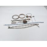 A collection of antique silver and white metal jewellery. Including bangles, an identity bracelet,