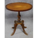 An Edwardian mahogany wine table with shell inlay raised on quadruped swept supports. H.55cm