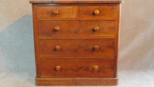 A Victorian flame mahogany chest of two short over three long drawers raised on plinth base. H.111