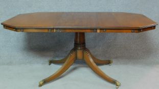 A Regency style mahogany dining table raised on fluted swept quadruped supports. H.79 W.169 D.84cm